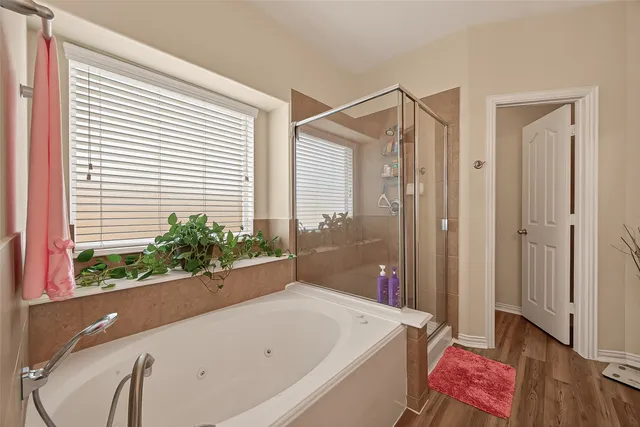 a bathroom with a bathtub and a shower