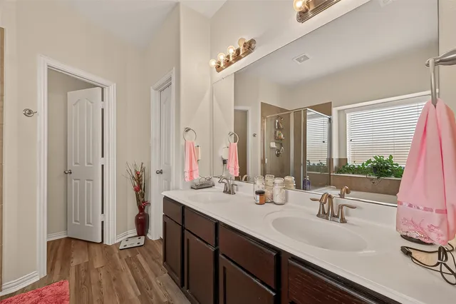 a bathroom with a double vanity sink and mirror
