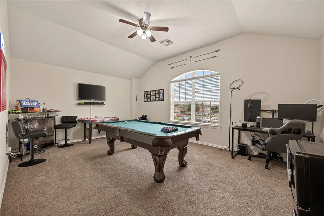 a room with furniture pool table and flat screen tv