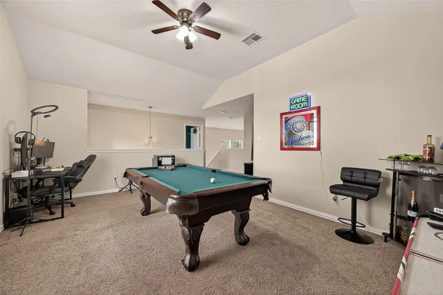 a room with pool table and windows