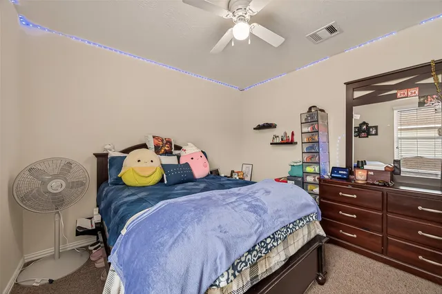 a bedroom with a bed and chandelier