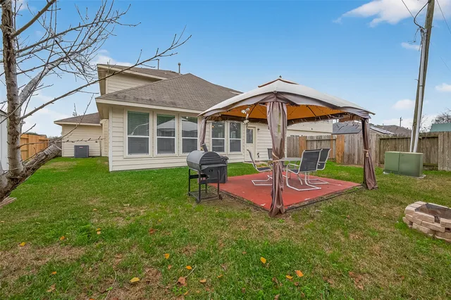 a view of a house with a yard patio and slide