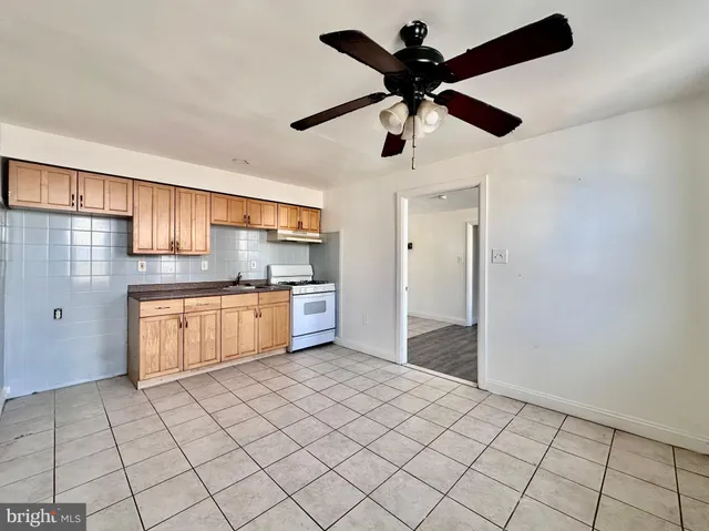 a kitchen with stainless steel appliances a cabinets and window