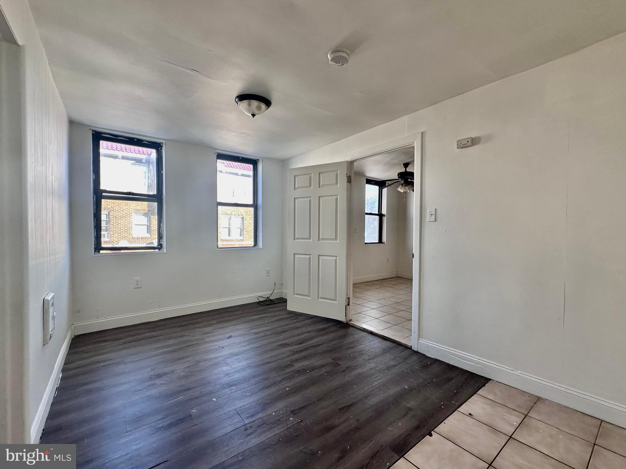 4060 East Roosevelt Boulevard Philadelphia, PA 19124 - Photo 12 of 13 an empty room with wooden floor and windows