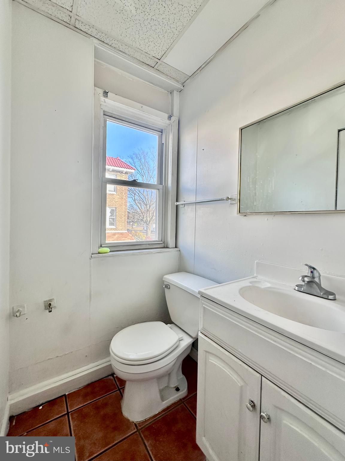 4060 East Roosevelt Boulevard Philadelphia, PA 19124 - Photo 10 of 13 a bathroom with a toilet a sink and a window