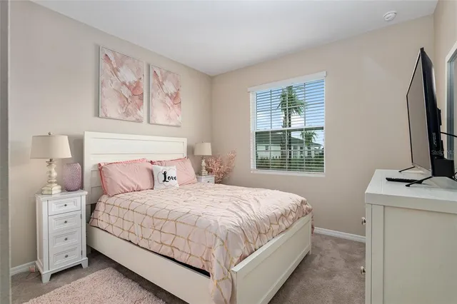 a bedroom with a bed and a painting on the wall