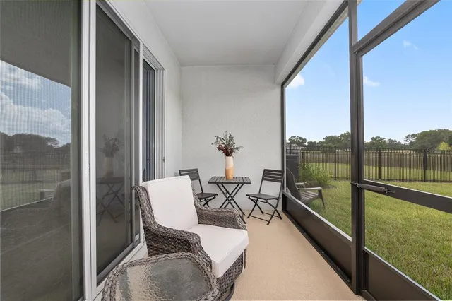 a view of a chairs and table in a balcony