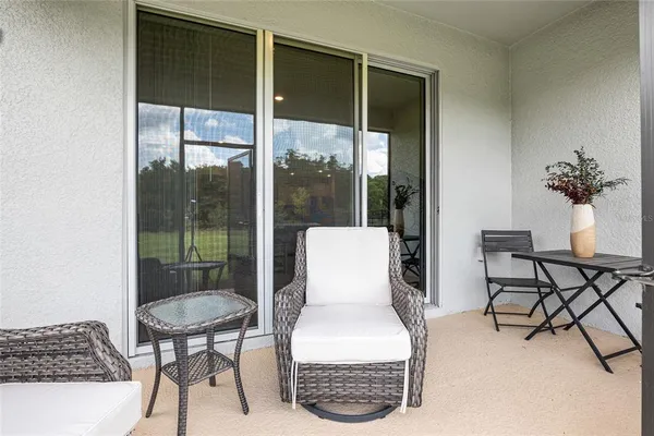 a backyard of a house with yard table and chairs