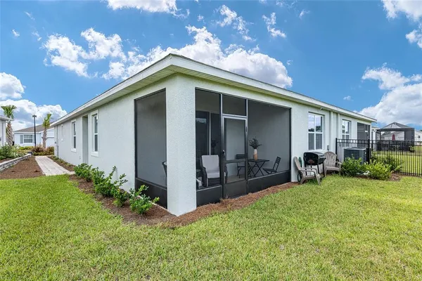 a view of a house with backyard porch and sitting area