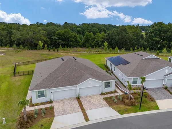 a view of a house with swimming pool and a yard