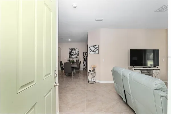 a view of a livingroom with furniture and a flat screen tv