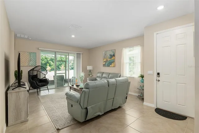 a living room with furniture and a large window