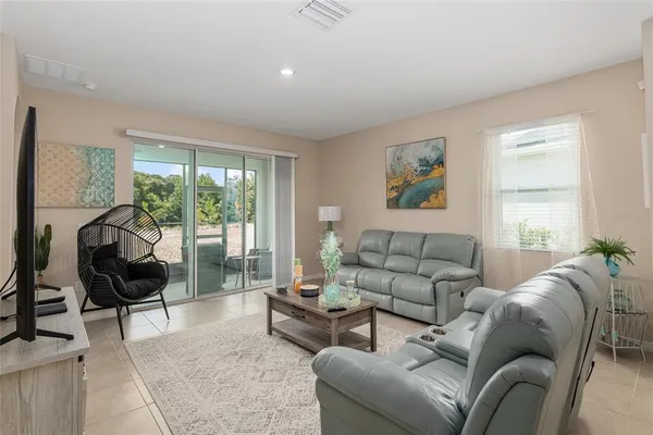 a living room with furniture and a large window