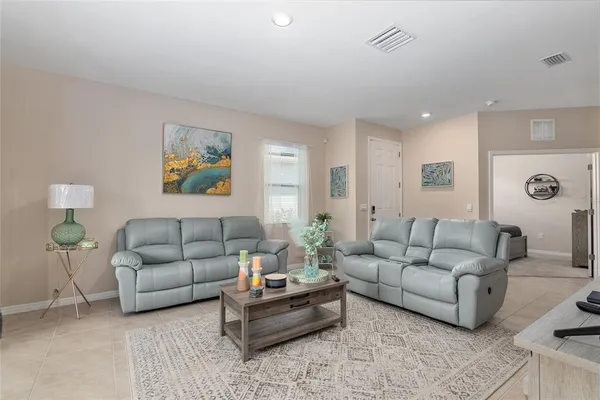 a living room with furniture and painting on the wall