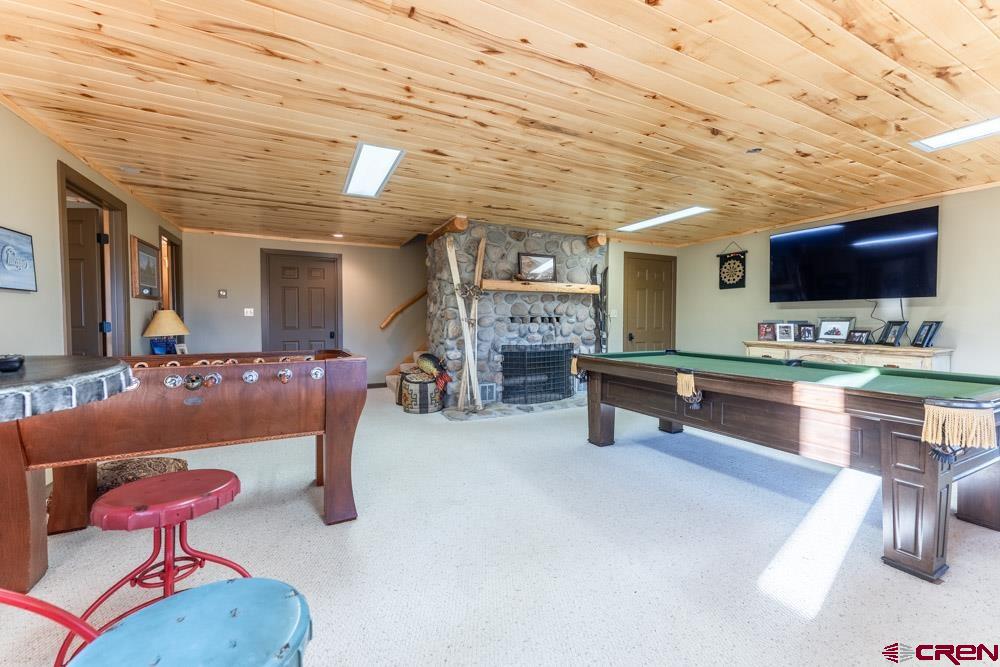 1851 Sioux Road Gunnison, CO 81230 - Photo 21 of 35 Downstairs Game Room/Living Area with Wood burning Fireplace