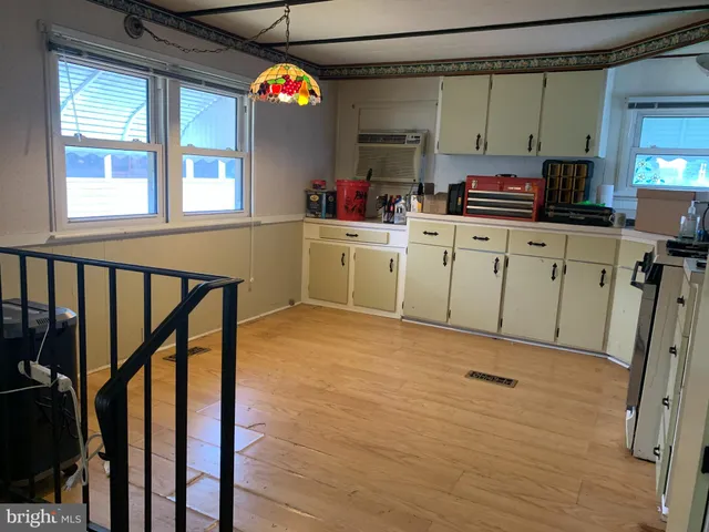 a kitchen with appliances cabinets and a window