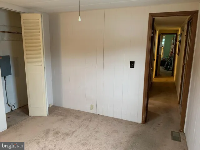 a view of a hallway to rooms