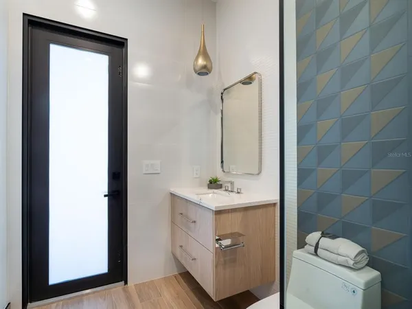 a bathroom with a sink a toilet and shower