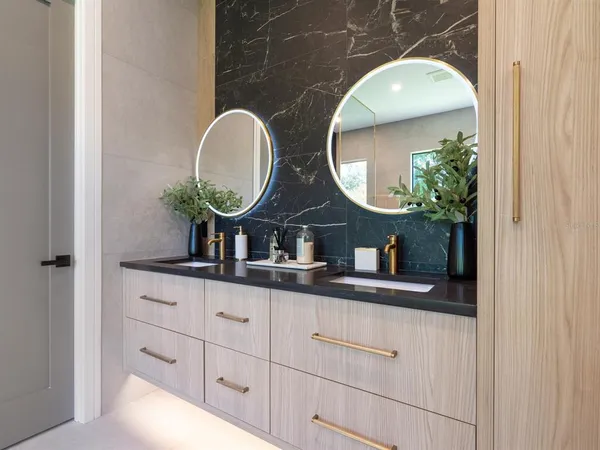 a bathroom with a double vanity sink and a mirror