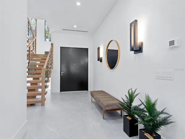 a view of entryway and hall with wooden floor