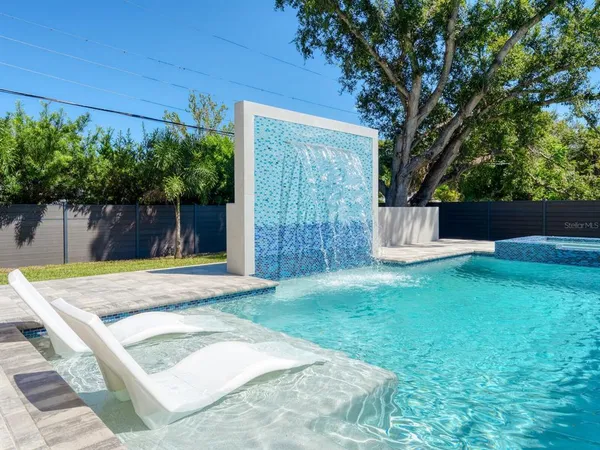 a view of a backyard with a tree
