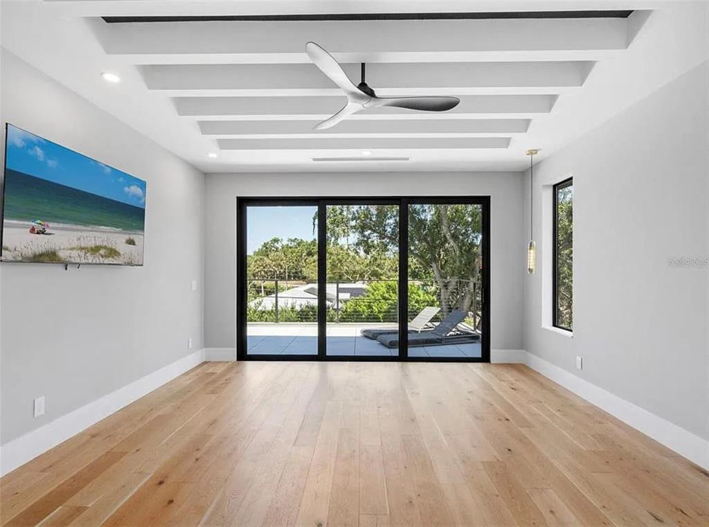 2467 Hyde Park Street Sarasota, FL 34239 - Photo 24 of 42 a view of an empty room with wooden floor and a window