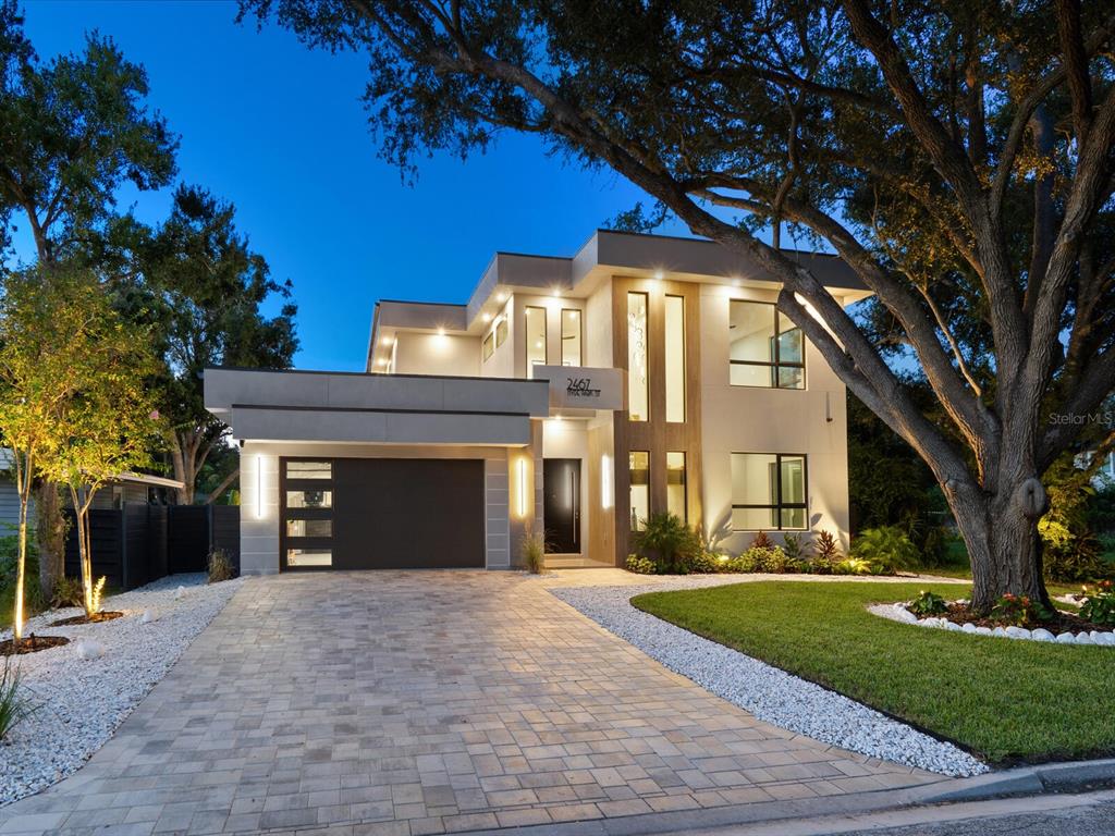 2467 Hyde Park Street Sarasota, FL 34239 - Photo 32 of 42 a front view of a house with a yard and a garage