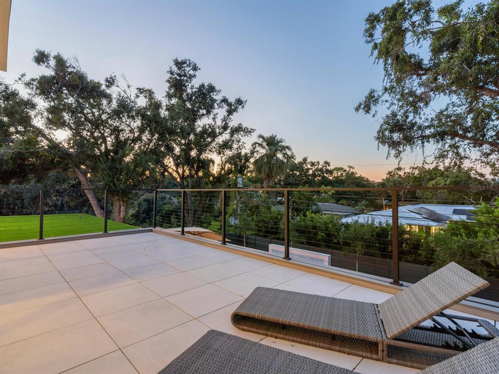 2467 Hyde Park Street Sarasota, FL 34239 - Photo 34 of 42 a view of a tennis ground with large trees