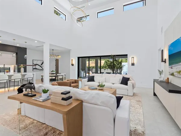 a living room with furniture a flat screen tv and a window