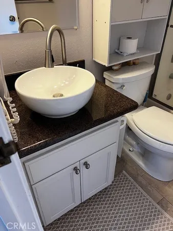 a bathroom with a toilet a sink and mirror