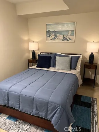 a large bed sitting in a bedroom next to a lamp