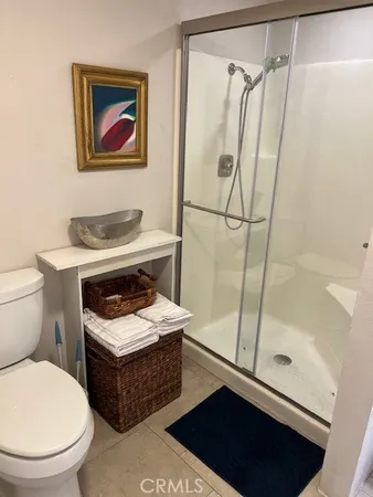 a bathroom with a sink a toilet a shower and a mirror