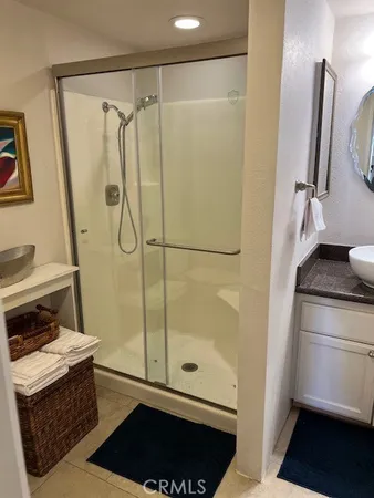 a bathroom with a shower and a sink