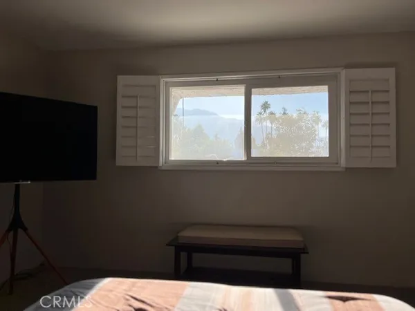 a bathroom with a sink a toilet and a window