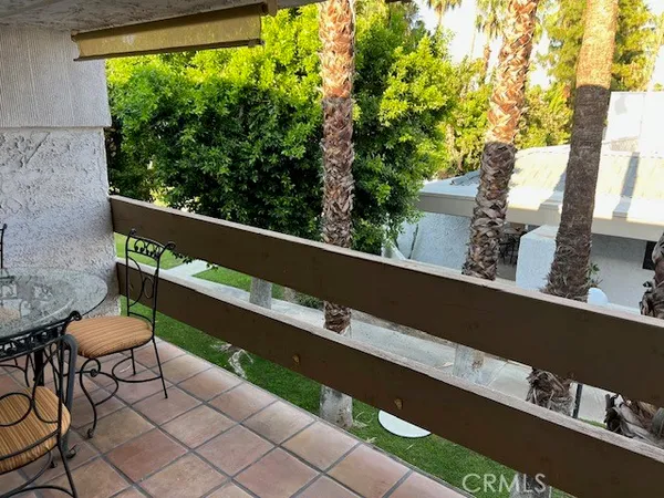 a balcony with table and chairs