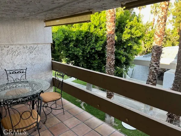a view of a chairs and table in patio