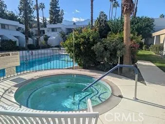 a view of a swimming pool with a backyard and trees