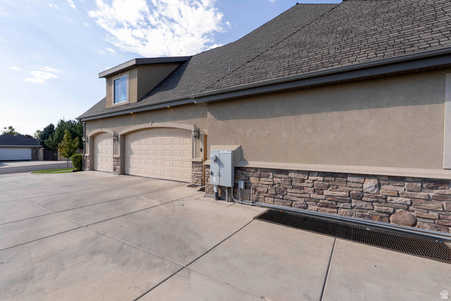 687 South 2080th Street East Springville, UT 84663 - Photo 92 of 149 Multi-car garage with arched entrances, stucco exterior, stone facade, and dormer window