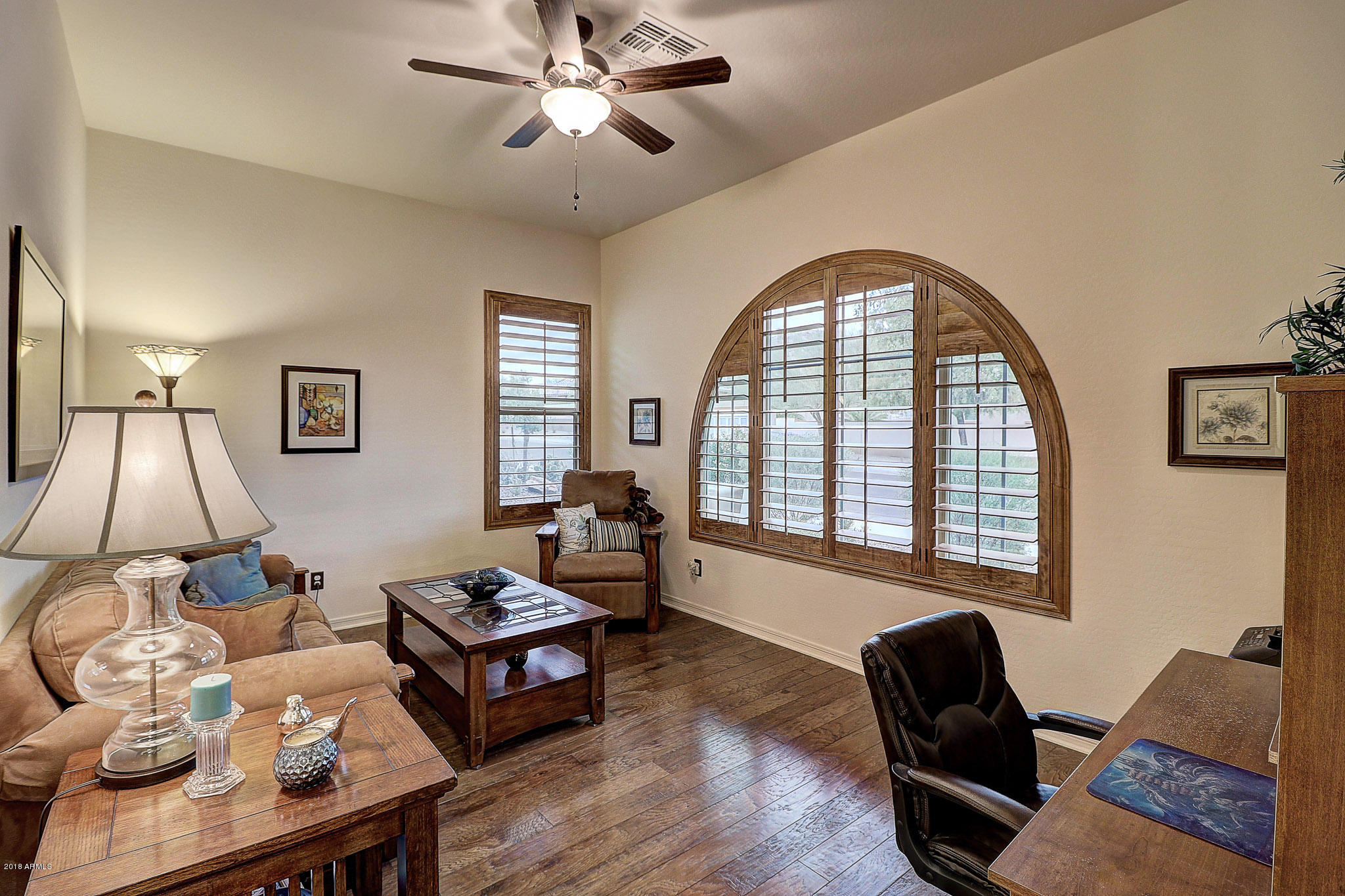 18271 West Desert Trumpet Road Goodyear, AZ 85338 - Photo 7 of 49 Wood Floor & Arched Plantation Shutters