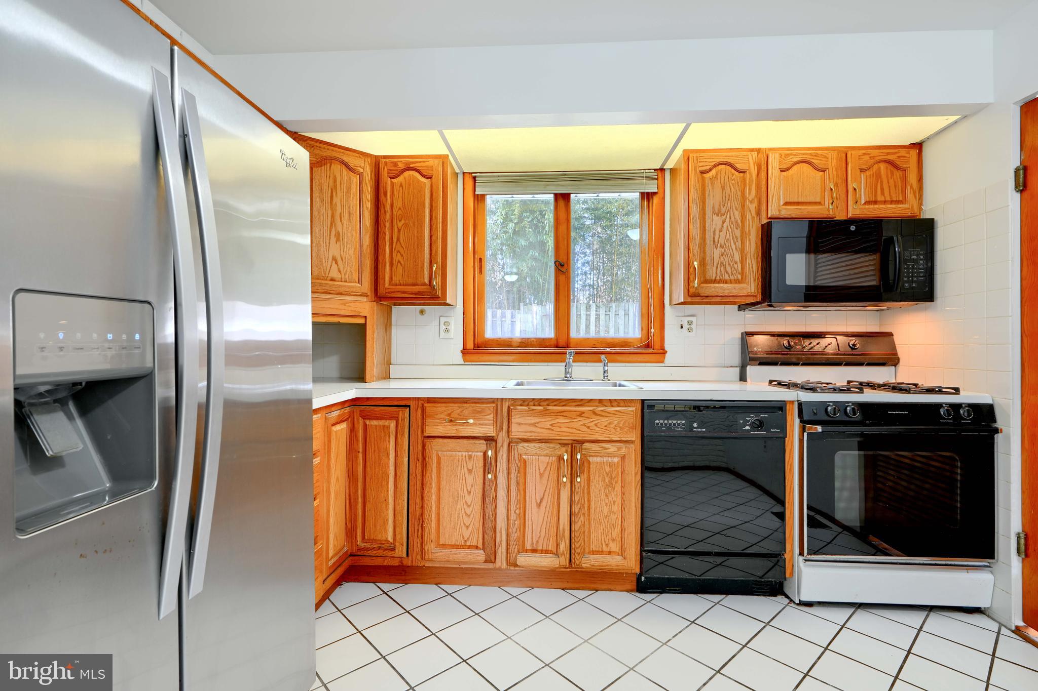 4425 Wynn Road Baltimore, MD 21236 - Photo 11 of 39 a kitchen with stainless steel appliances granite countertop a refrigerator and a stove top oven