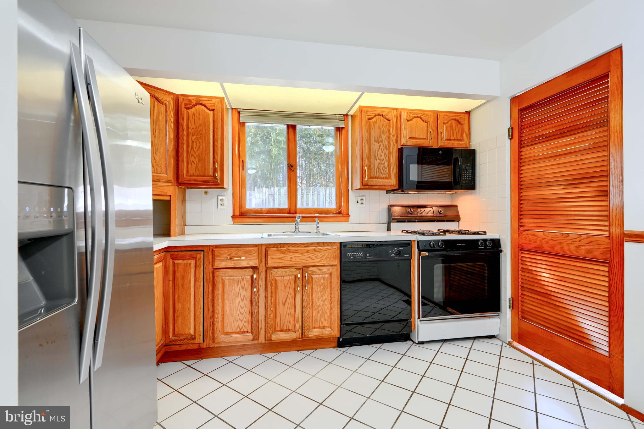 4425 Wynn Road Baltimore, MD 21236 - Photo 12 of 39 a kitchen with stainless steel appliances granite countertop a refrigerator and a sink