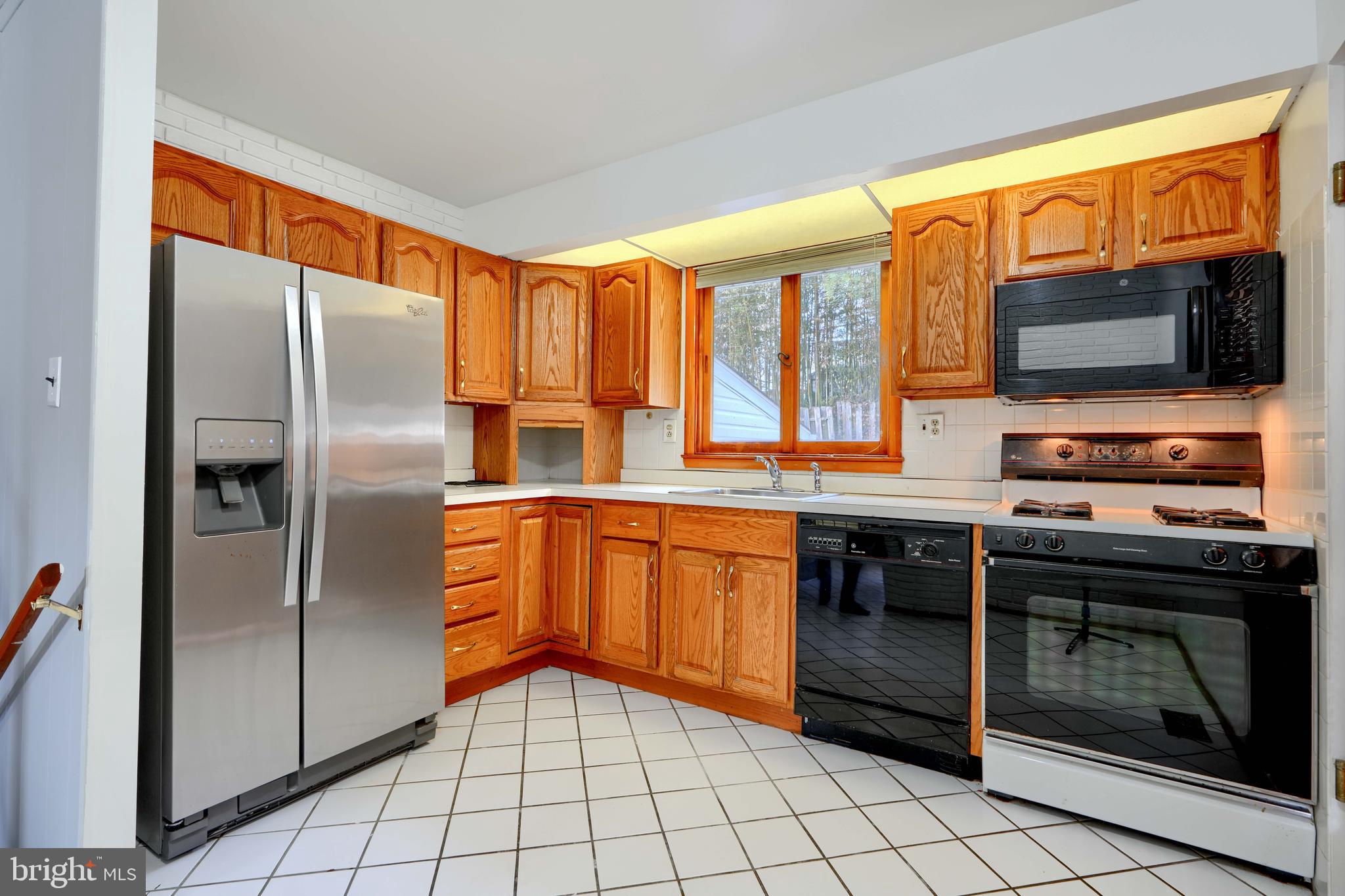 4425 Wynn Road Baltimore, MD 21236 - Photo 15 of 39 a kitchen with stainless steel appliances granite countertop a refrigerator and a stove top oven