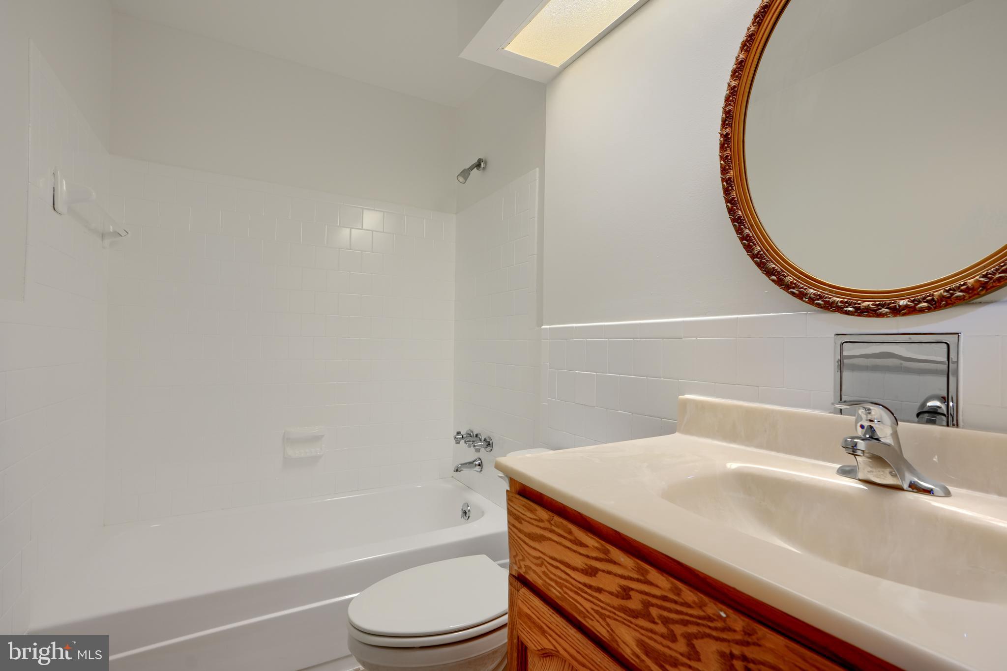 4425 Wynn Road Baltimore, MD 21236 - Photo 23 of 39 a bathroom with a sink a toilet and a mirror