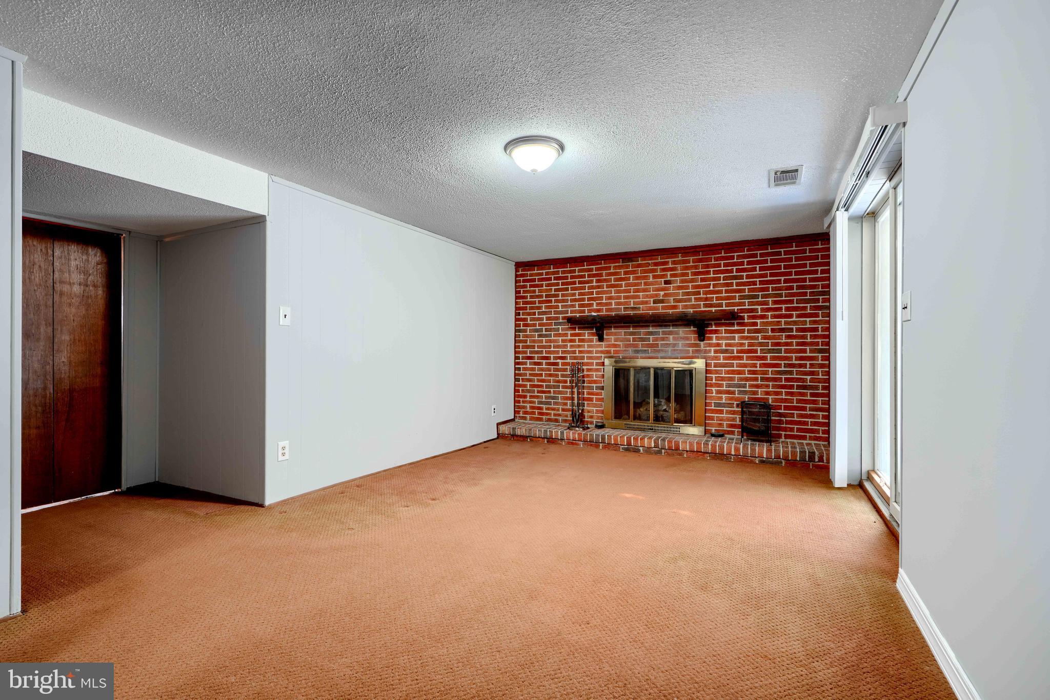 4425 Wynn Road Baltimore, MD 21236 - Photo 32 of 39 an empty room with a fireplace and window
