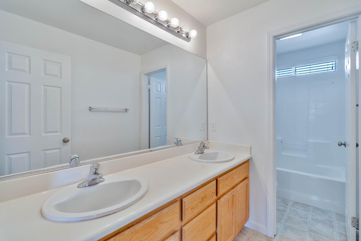 863 Chianti Circle Coalinga, CA 93210 - Photo 11 of 35 a bathroom with a sink and a mirror