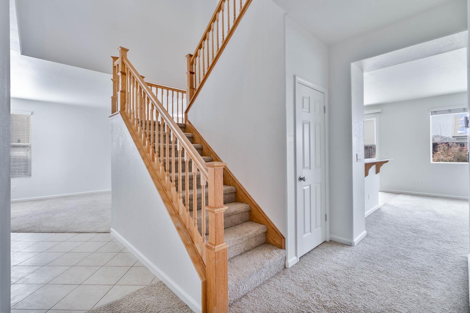 863 Chianti Circle Coalinga, CA 93210 - Photo 22 of 35 a view of staircase with railing and white walls