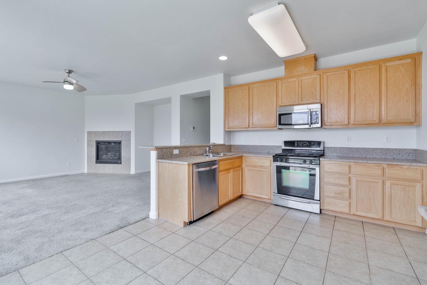 863 Chianti Circle Coalinga, CA 93210 - Photo 26 of 35 a kitchen with white cabinets and appliances