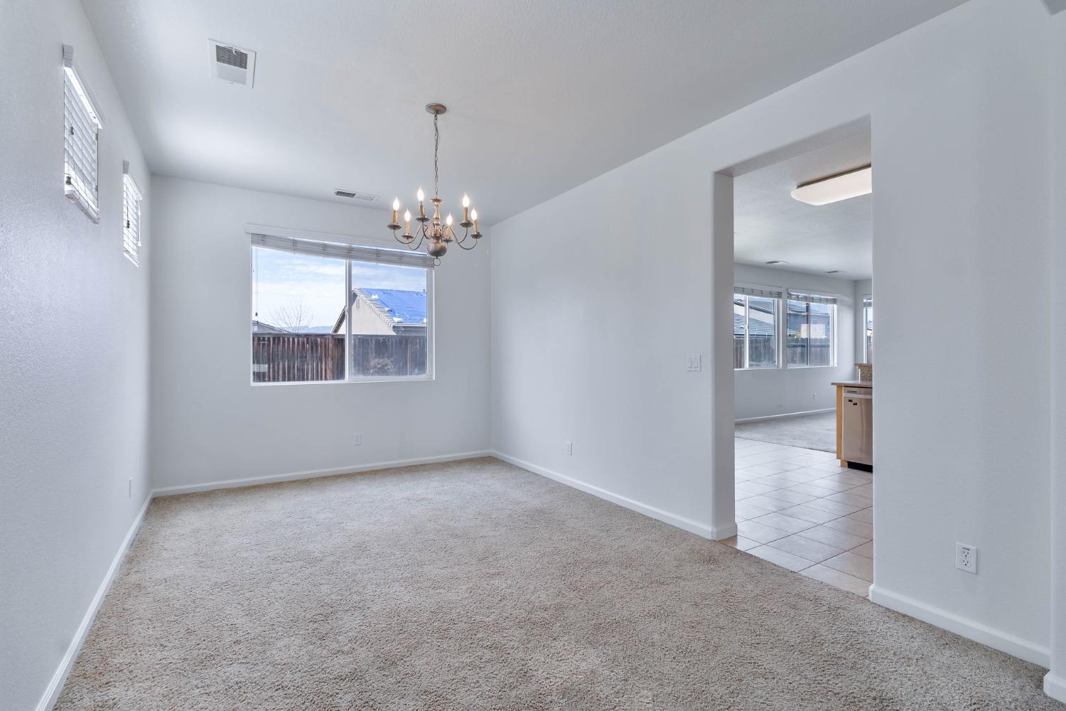 863 Chianti Circle Coalinga, CA 93210 - Photo 29 of 35 wooden floor in an empty room with a window