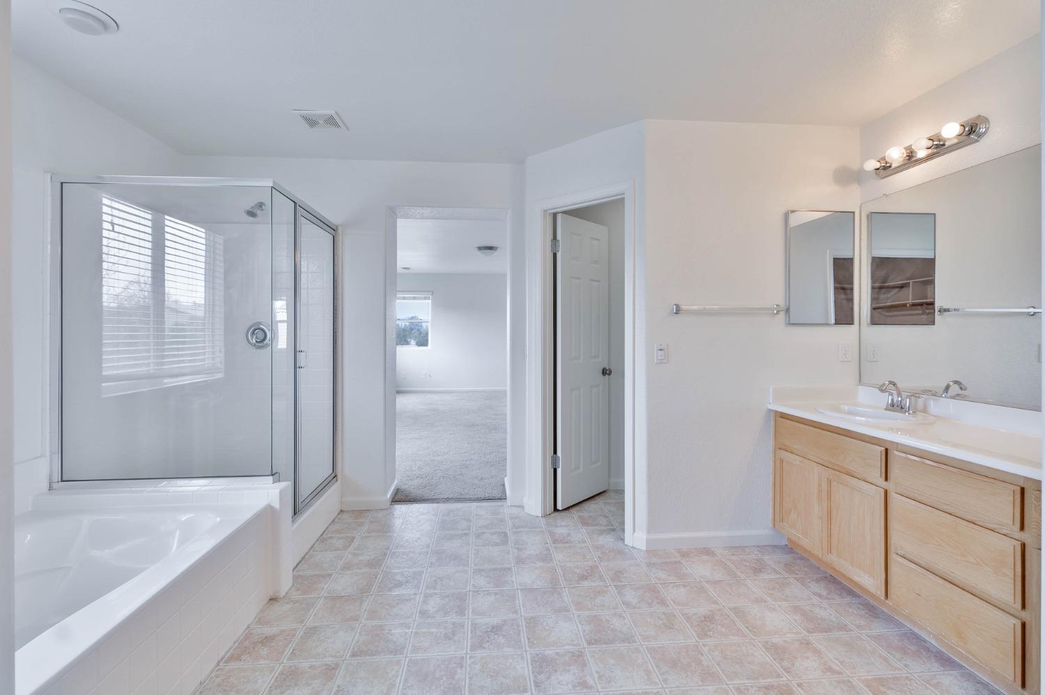 863 Chianti Circle Coalinga, CA 93210 - Photo 6 of 35 a bathroom with a tub sink shower and mirror