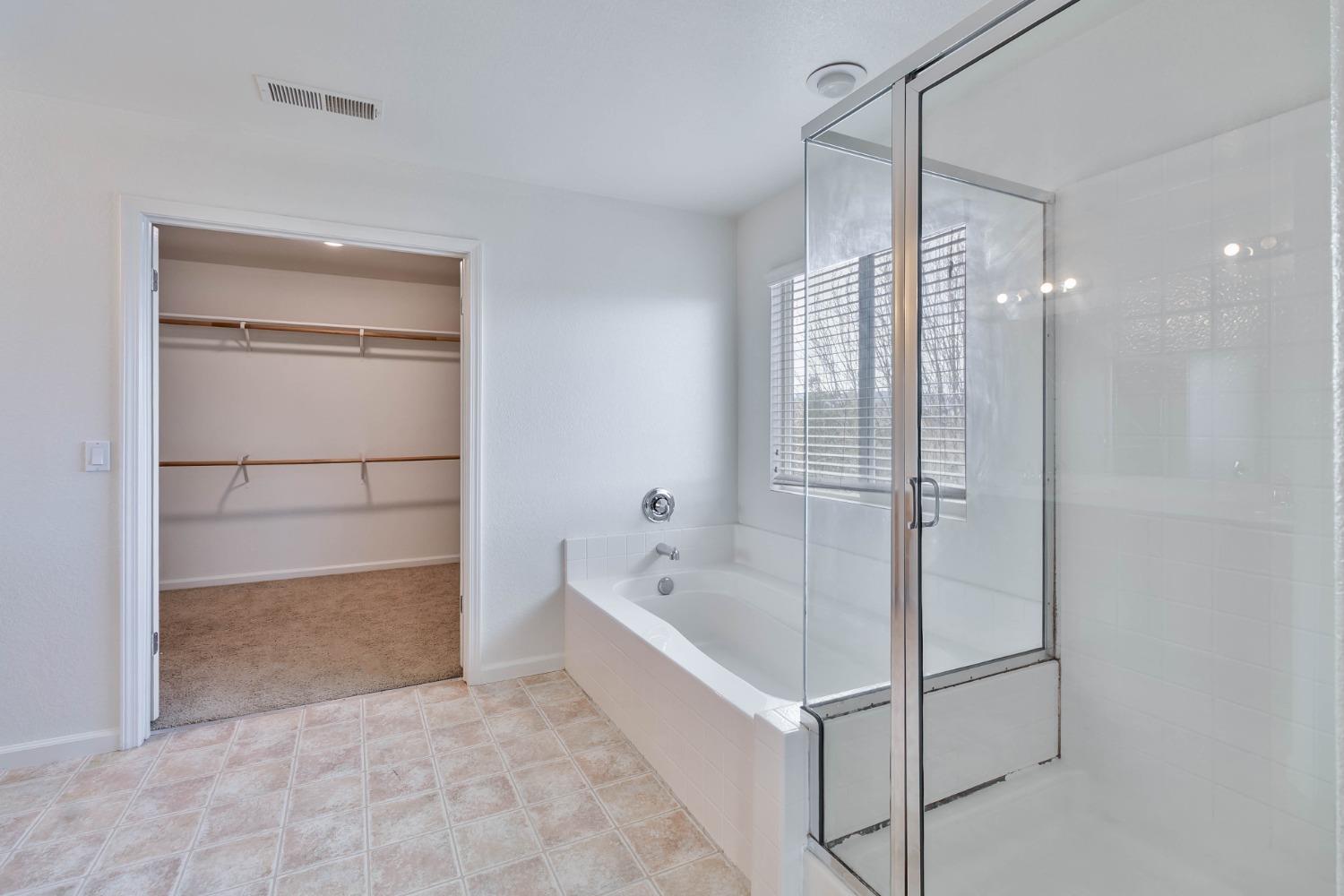863 Chianti Circle Coalinga, CA 93210 - Photo 7 of 35 a bathroom with a bathtub and a shower